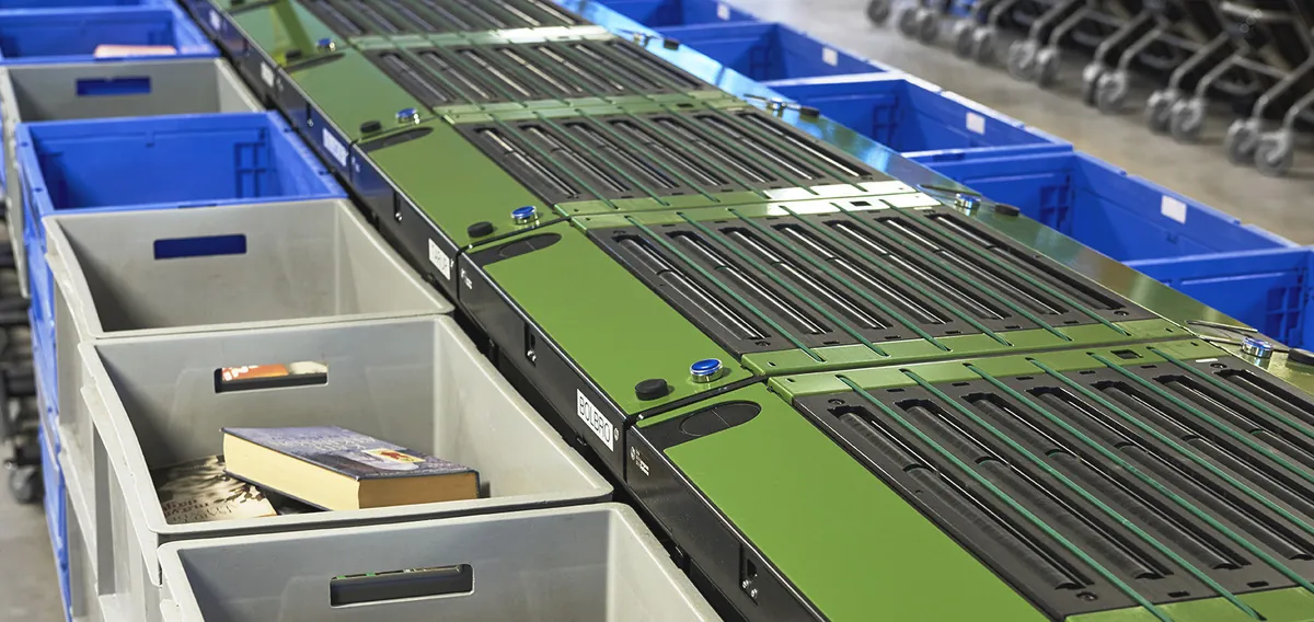 Close-up of a sorting line with items landing in destination bins